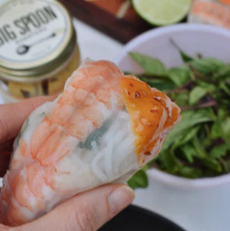 pring roll with bowl of greens