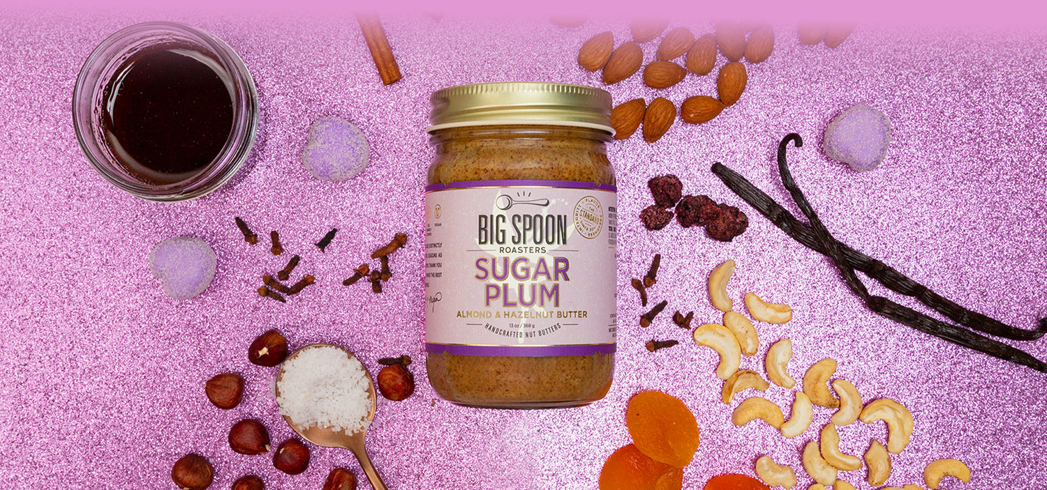 Jar of 'Big Spoon' Sugar Plum Nut Butter with ingredients on a pink background