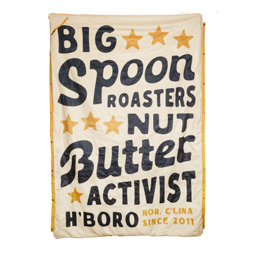 Big Spoon Roasters Beach Blanket that states Big Spoon Roasters Nut Butter Activist H'Boro N'Clina Since 2011