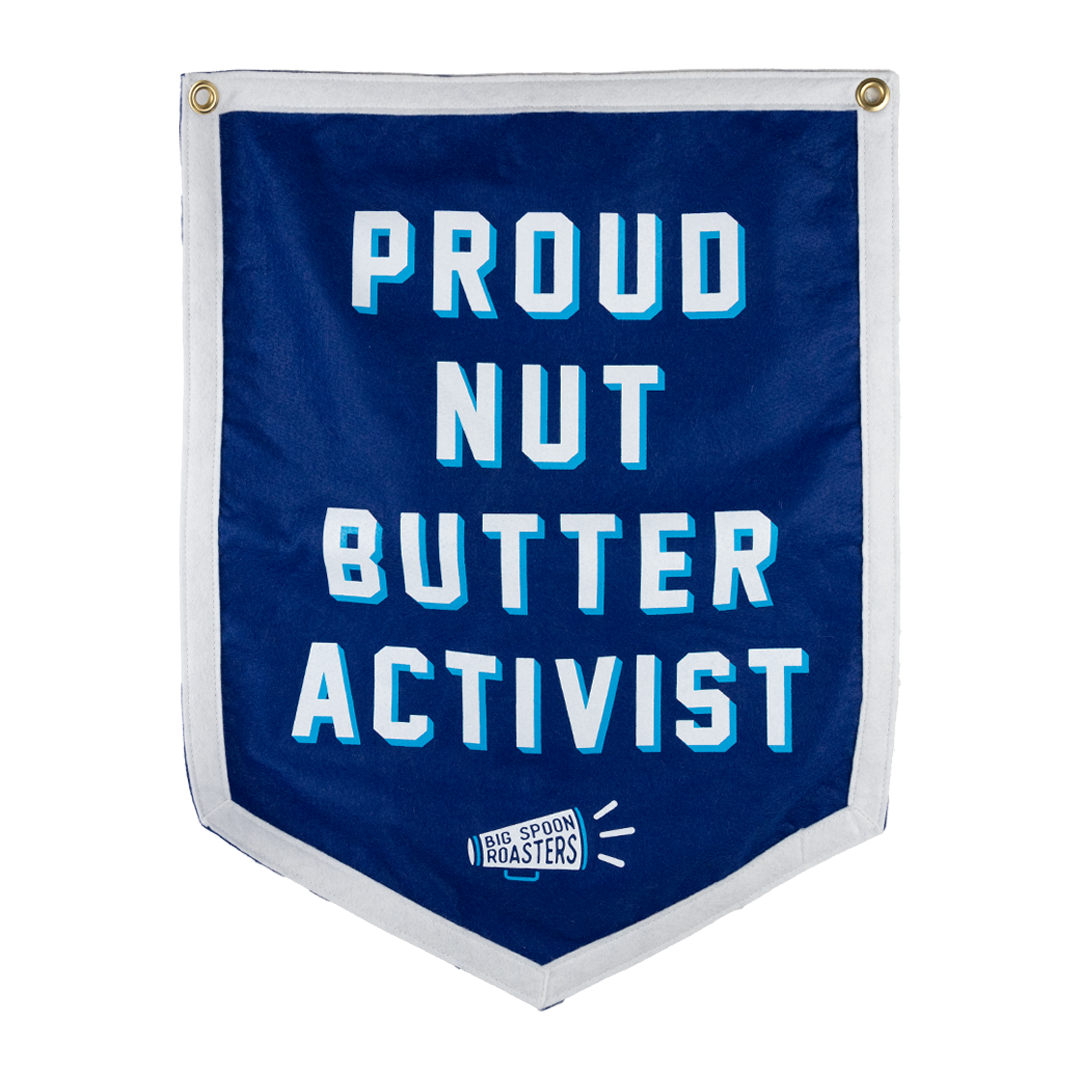 Blue Camp Flag reading PROUD NUT BUTTER ACTIVIST with a megaphone reading BIG SPOON ROASTERS at the bottom center