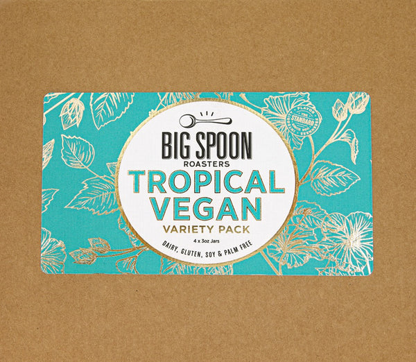 Cardboard box cover with Tropical Vegan Variety Pack Label on top, made with a teal background and gold foil tropical flower art