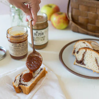 Spooning Salted Caramel Apple Butter onto brioche