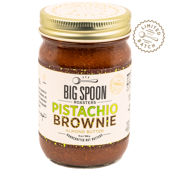 Jar of Big Spoon Roasters Pistachio Brownie almond butter with gold lid on a white background