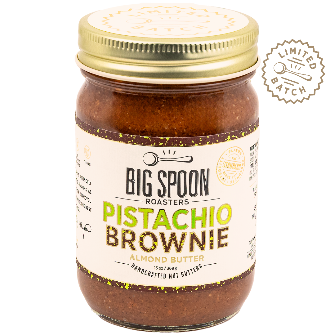 Jar of Big Spoon Roasters Pistachio Brownie almond butter with gold lid on a white background