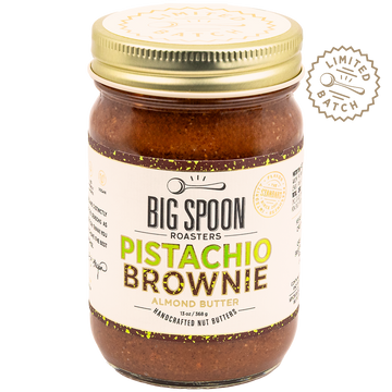 Jar of Big Spoon Roasters Pistachio Brownie almond butter with gold lid on a white background