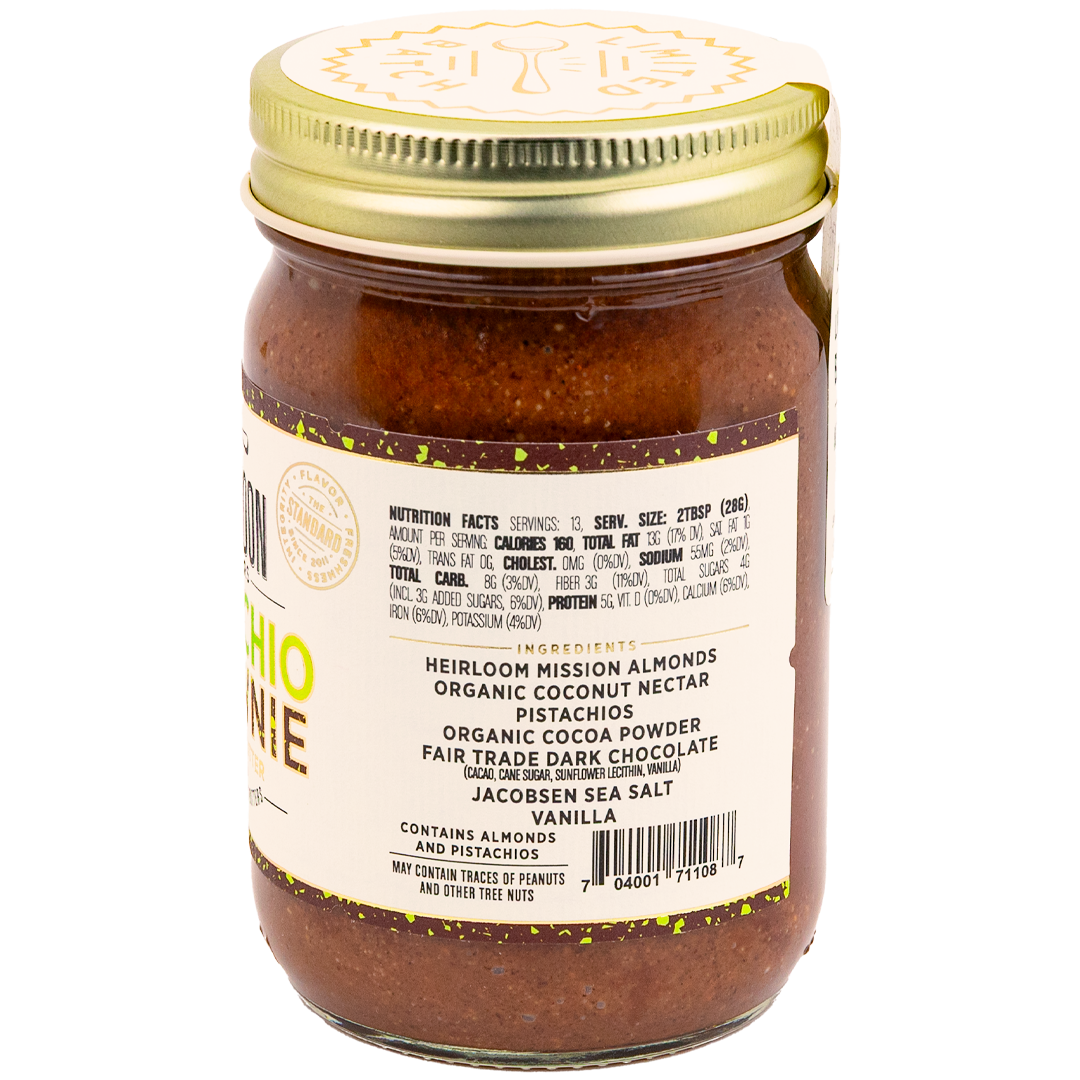 Jar of Pistachio Brownie Almond Butter showing ingredients and nutrition info