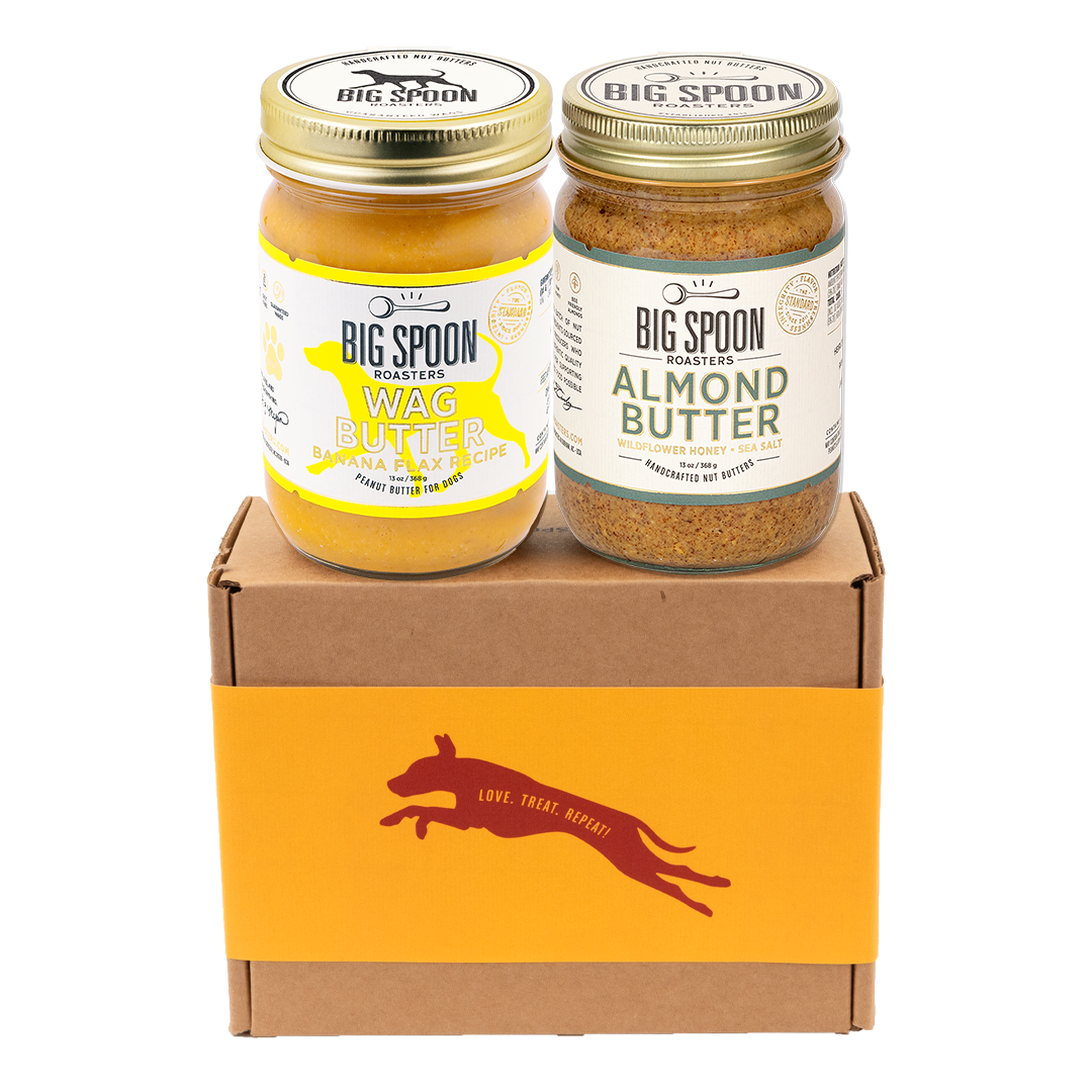 Two jars of Big Spoon Roasters nut butter - Banana Flax Wag Butter and Almond Butter with Wildflower Honey on a branded box 