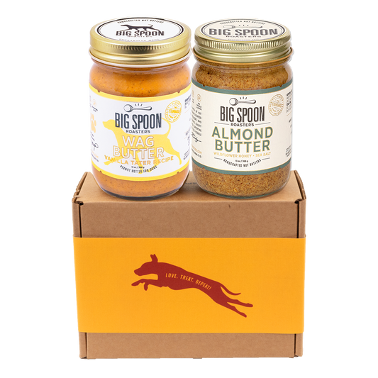 Jar of Vanilla Tater Wag Butter and a jar of Almond Butter with Wildflower Honey on top of a gift box