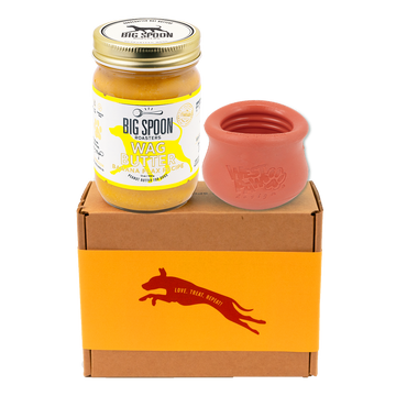 Jar of 'Big Spoon Roasters' Wag Butter with an red west paw toppl on a branded box.