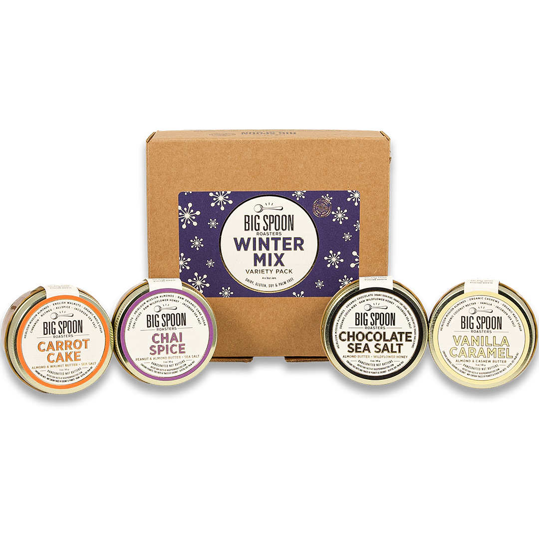 3oz Winter Mix Variety Pack box with mini jars of Carrot Cake Almond & Walnut Butter, Chai Spice Peanut & Almond Butter, Chocolate Sea Salt Almond Butter, and Vanilla Caramel Almond & Cashew Butter in front