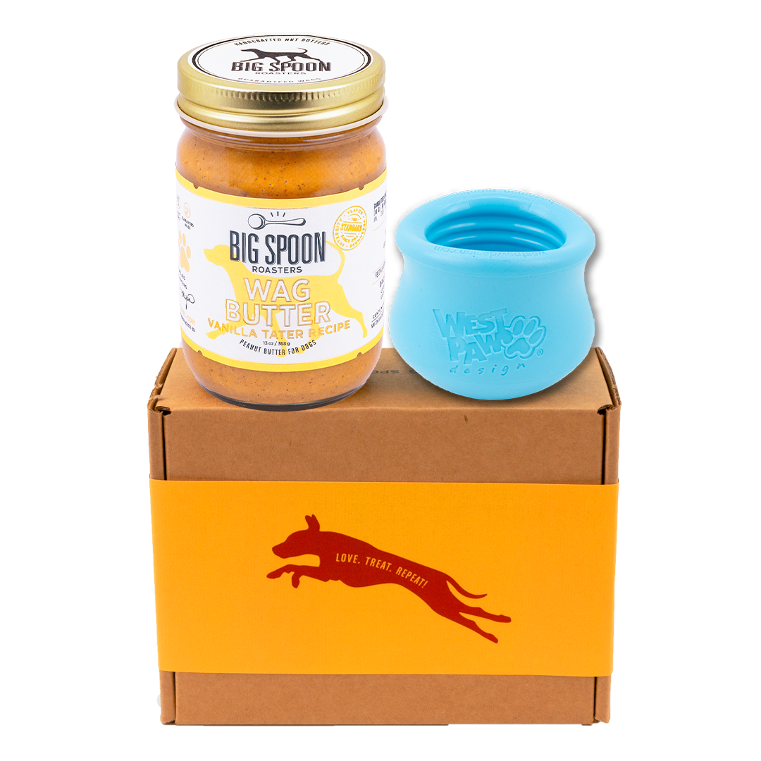 Jar of Vanilla Tater Wag Butter and an aqua West Paw Toppl toy on top of a gift box