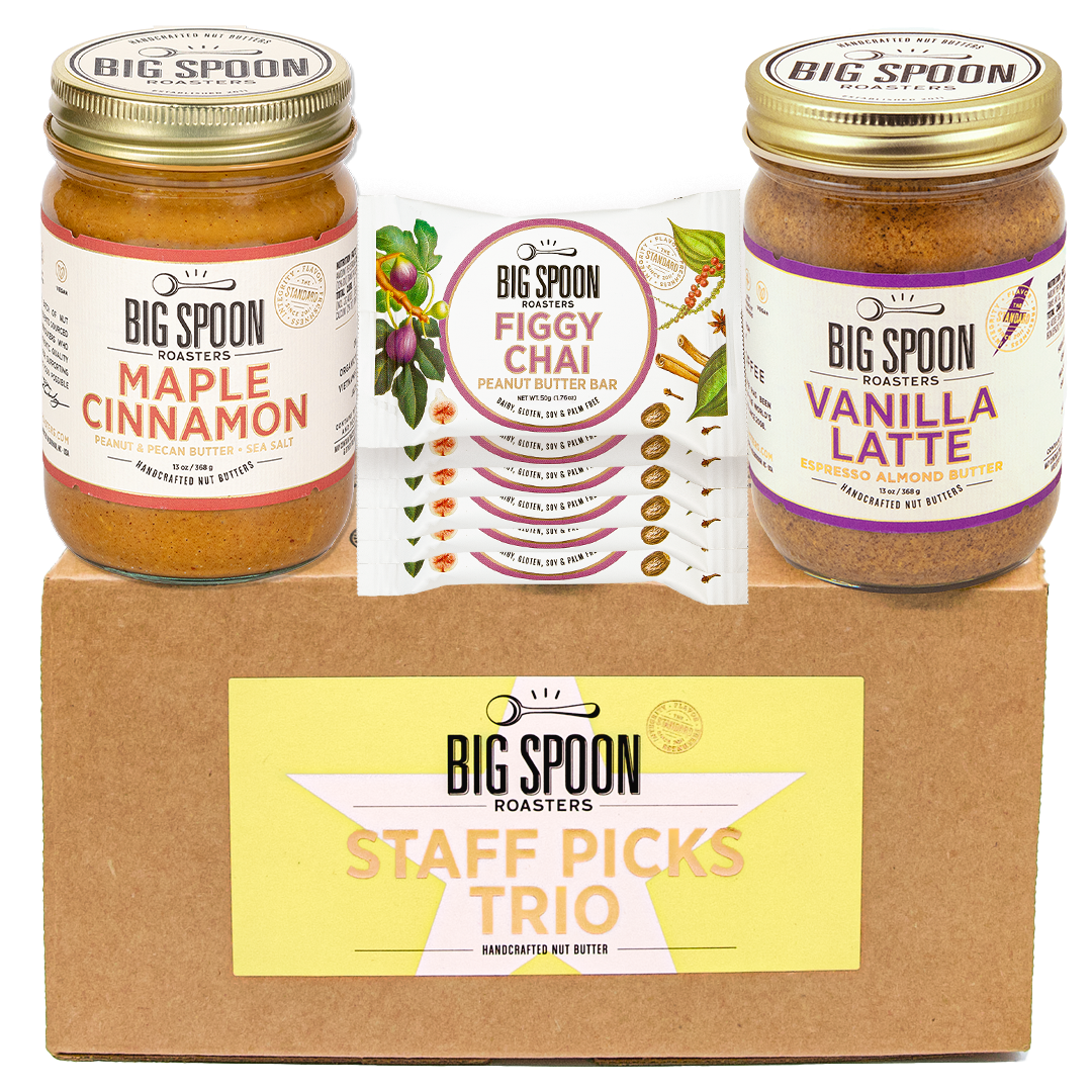 Big Spoon Roasters staff picks trio with jars of maple cinnamon, figgy chai bars, and vanilla latte on a cardboard box.