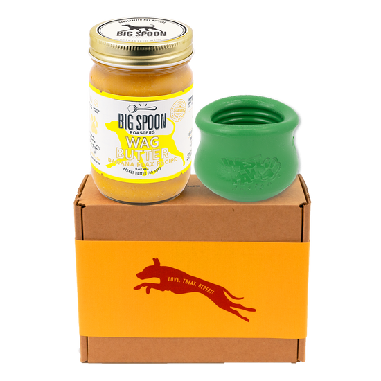 Jar of 'Big Spoon Roasters' Wag Butter with a green west paw toppl on a branded box.