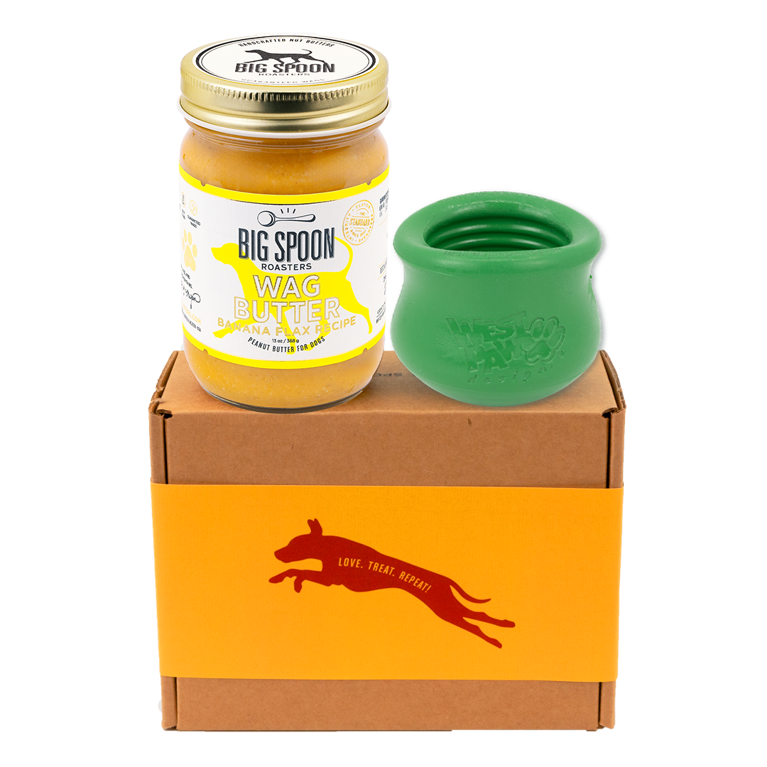 Jar of 'Big Spoon Roasters' Wag Butter with a green west paw toppl on a branded box.