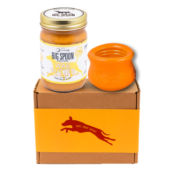 Jar of Vanilla Tater Wag Butter and an orange West Paw Toppl toy on top of a gift box