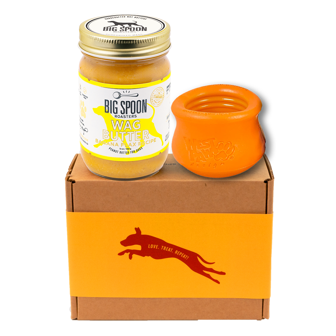 Jar of 'Big Spoon Roasters' Wag Butter with an orange west paw toppl on a branded box.
