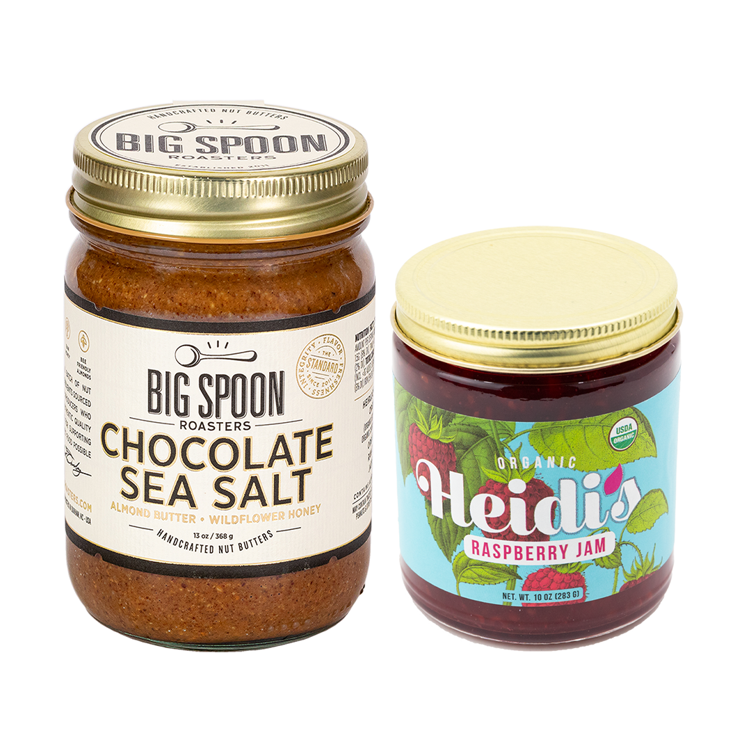 jar of Chocolate Sea Salt Almond Butter next to a jar of Heidi's Raspberry Jam