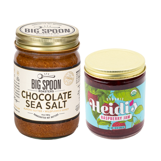 jar of Chocolate Sea Salt Almond Butter next to a jar of Heidi's Raspberry Jam