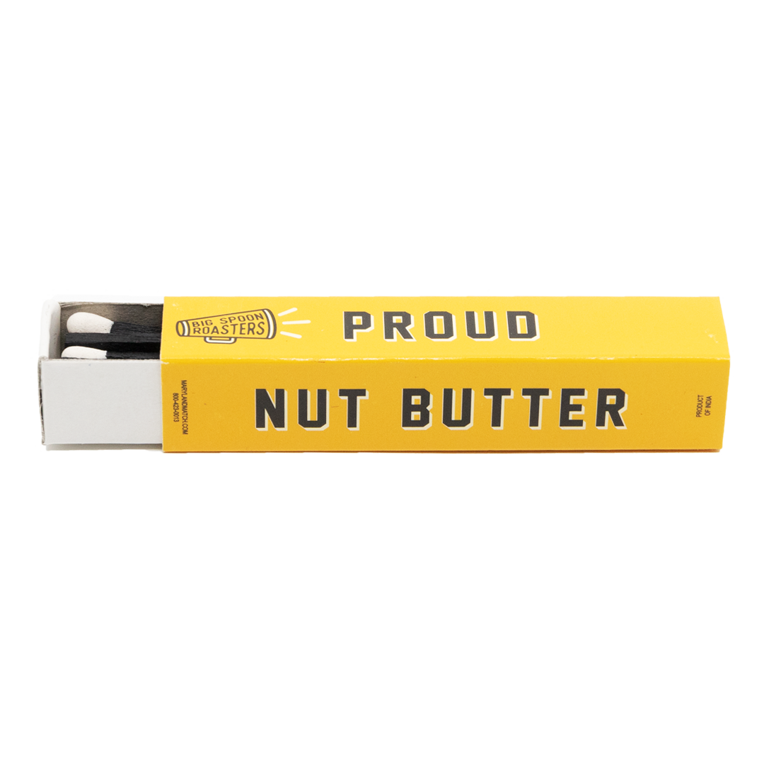 Big Spoon Roasters yellow matchbox reading "PROUD NUT BUTTER ACTIVIST"