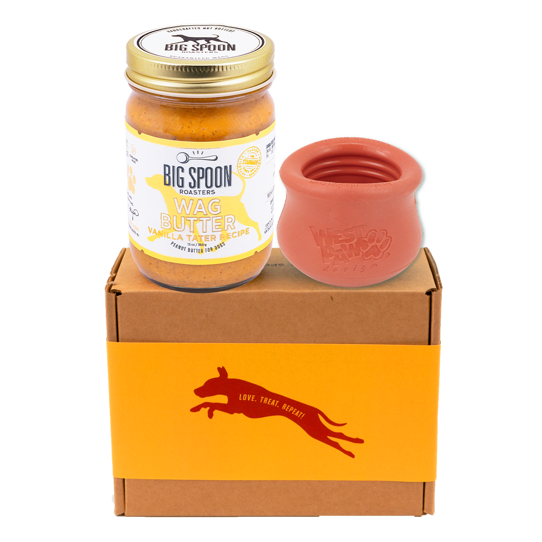 Jar of Vanilla Tater Wag Butter and a red West Paw Toppl toy on top of a gift box