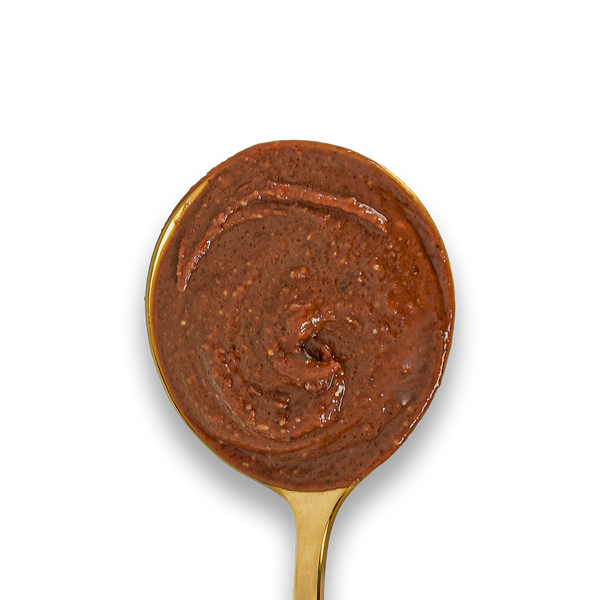  Dark Chocolate Hazelnut & Almond Butter swirled on a golden spoon. 