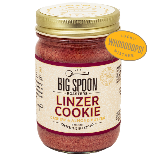 Jar of Big Spoon Roasters Linzer Cookie cashew and almond butter wth a badge overlaid that says LUCKY WHOOPS MISTAKE