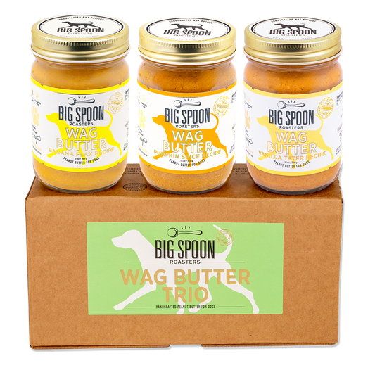 Three jars of Big Spoon Roasters Wag Butter on a cardboard box with the brand logo.