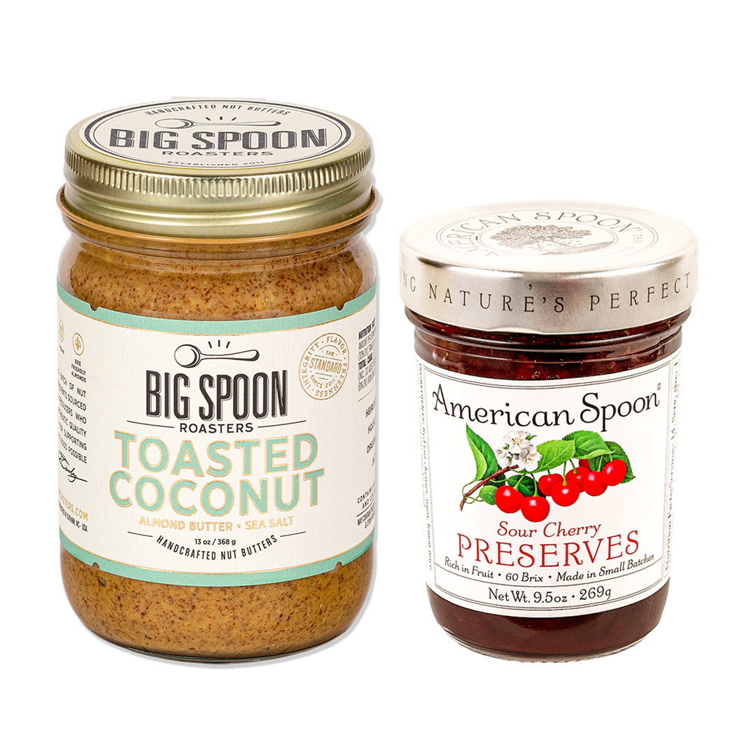 One jar of peanut butter from Big Spoon Roasters and one jar of sour cherry preserves from American Spoon on white background