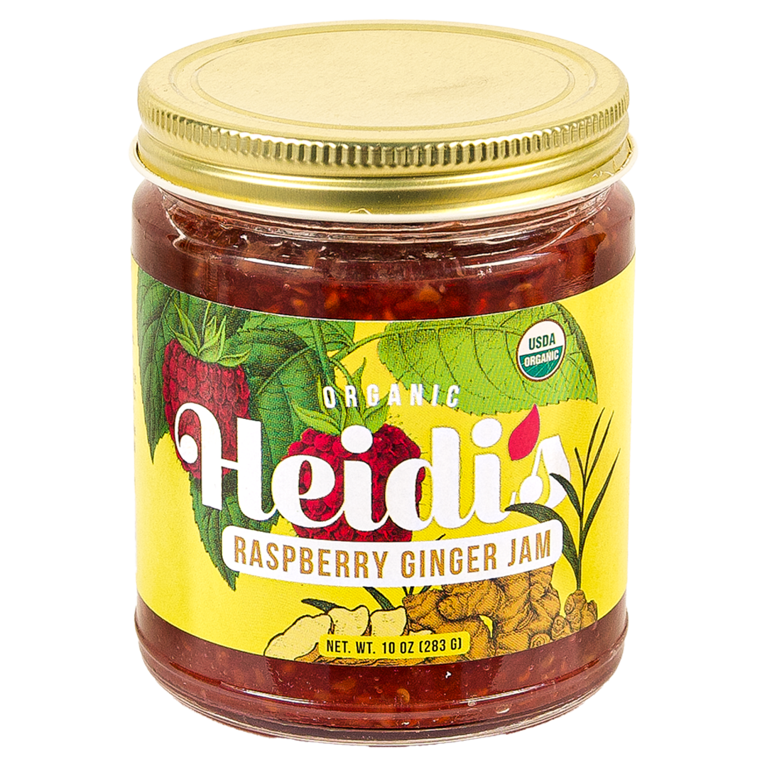 10 oz glass jar of Heidi's Raspberry Ginger Jam with bright yellow label showing drawn raspberries and ginger