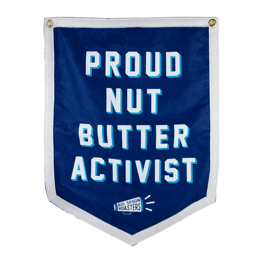 Blue Camp Flag reading PROUD NUT BUTTER ACTIVIST with a megaphone reading BIG SPOON ROASTERS at the bottom center