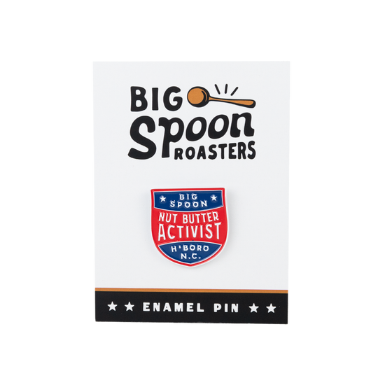 red, blue, and white enamel pin on a backing reading BIG SPOON ROASTERS ENAMEL PIN