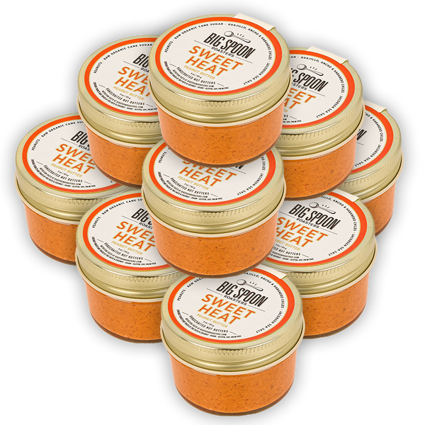 Small tower of about 12 3oz jars of Sweet Heat Peanut Butter